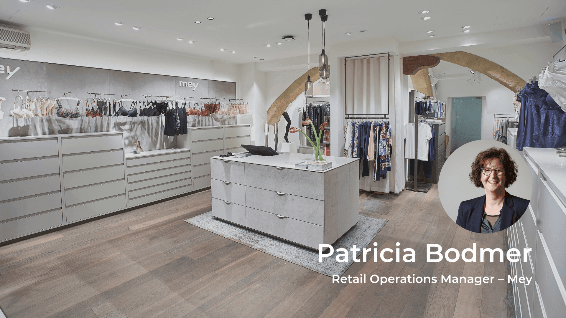 Modern clothing retail store interior with a headshot of Patricia Bodmer, Retail Operations Manager.