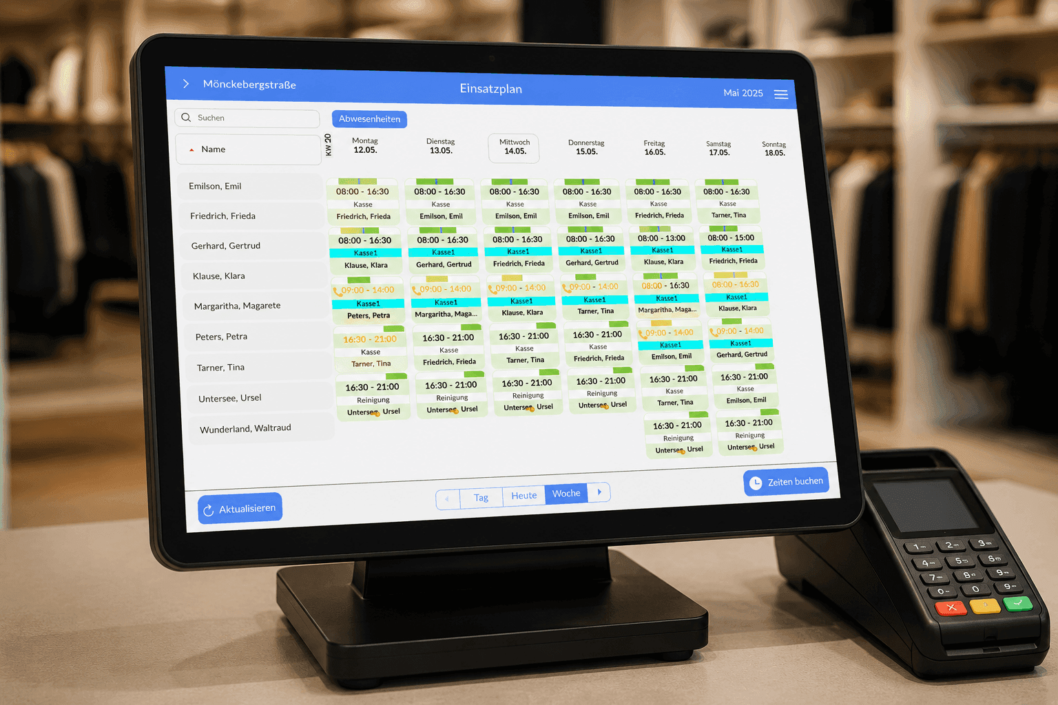 Retail POS system showing an employee schedule on screen, with a payment terminal.