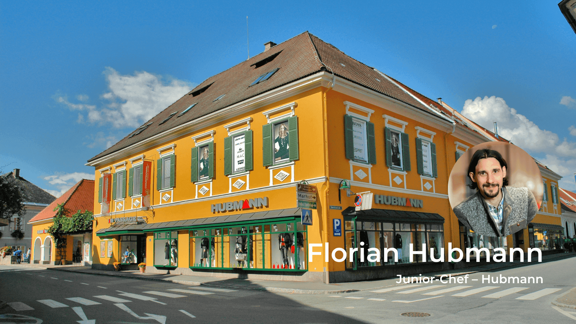 Historic yellow building with green shutters on a street, featuring Florian Hubmann, Junior-Chef.