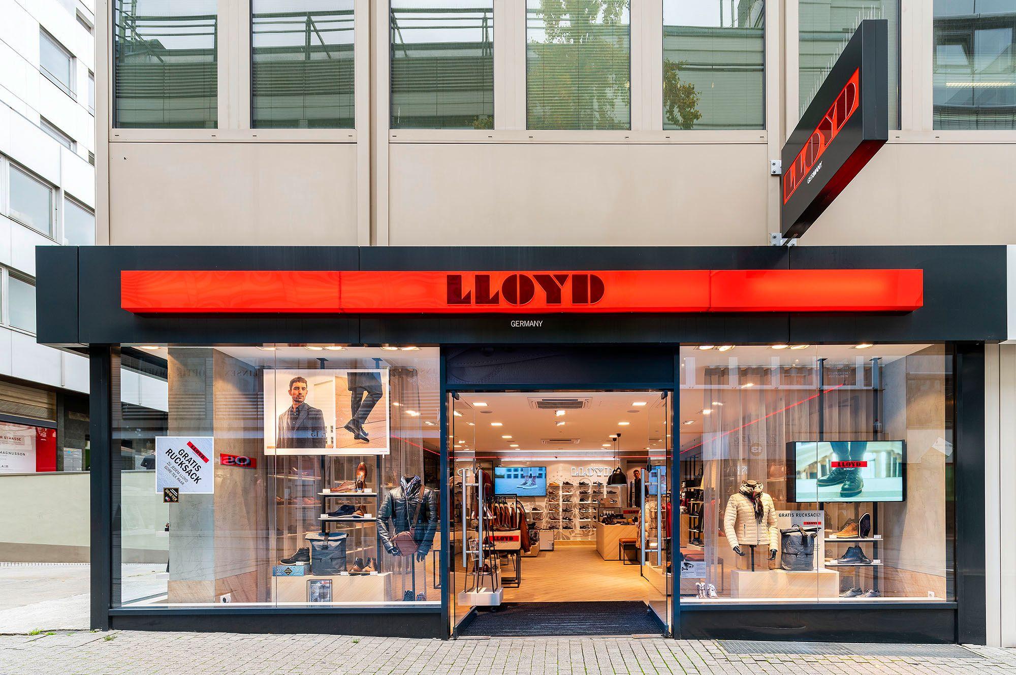 LLOYD shoe store storefront with a prominent red illuminated sign and display windows.