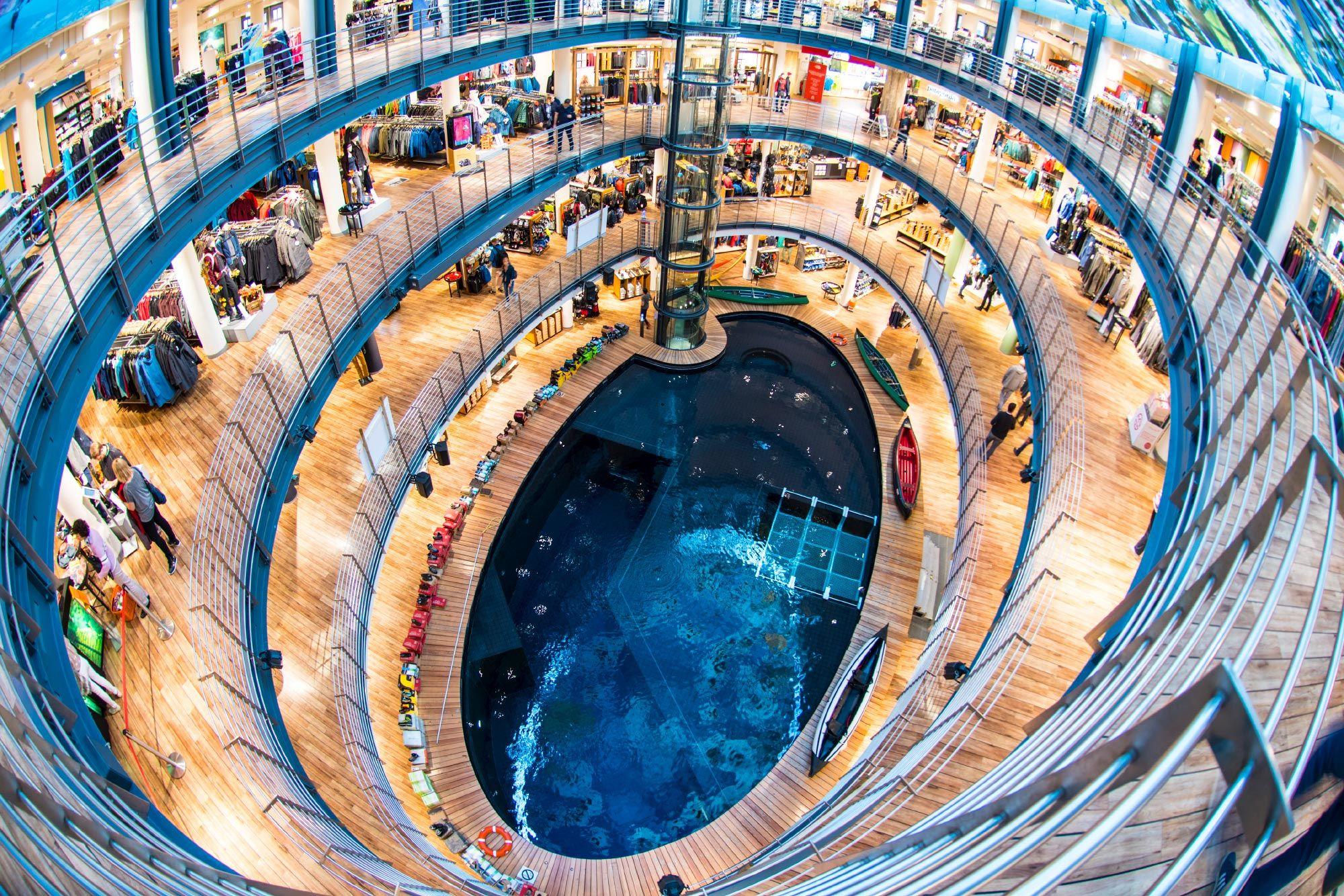 High-angle view of a spiraling multi-story shopping mall with a central blue feature.
